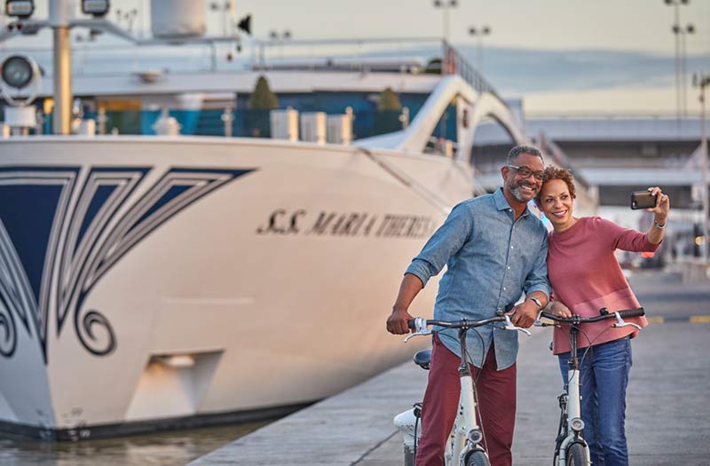 Uniworld docked Vienna couple riding bikes